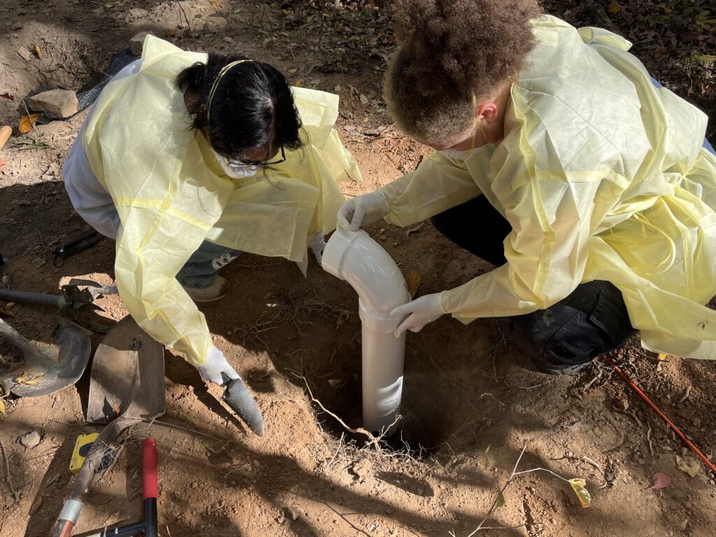 Students and faculty installing equipment needed for forensic research in the body farm.